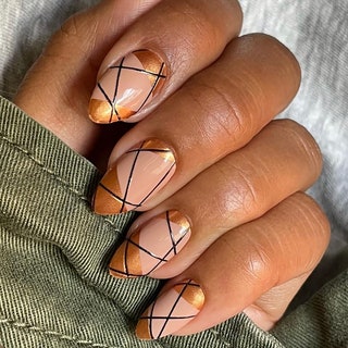 Manicured nails with a design featuring lines of various shapes colors and sizes
