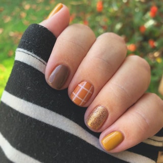 A manicure in shades of brown gold and yellow