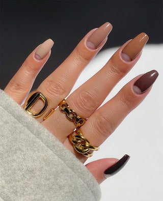 Manicured hand painted in dark brown beige and hues of light brown