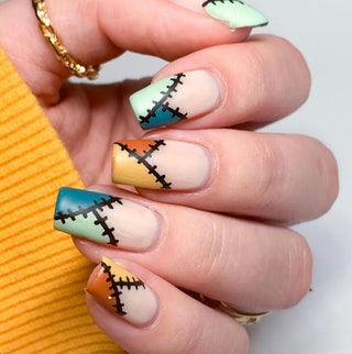 Manicured hand with illustrations of patches on the tips