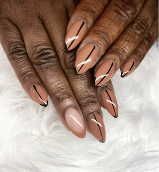 Manicured hands painted with a nudecolored shade of nail polish