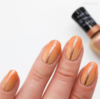 Manicured hand painted with shades of orange and some sparkle